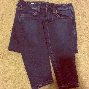 Dark-wash skinny jeans.